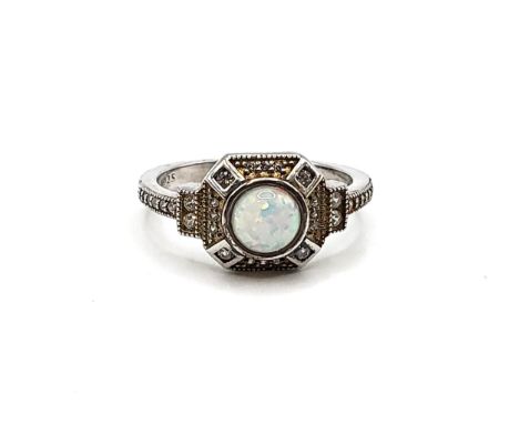 A silver and cubic zirconia ring with central opal panel. Size P 3.4gms