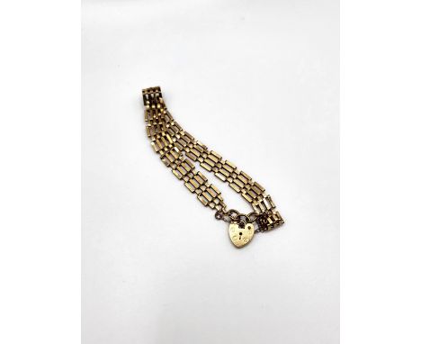 A four bar gate bracelet in 9ct yellow gold with padlock clasp and safety chain. 5.2gms