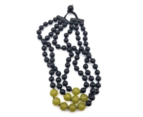 A choker length multi strand black onyx and mutton-fat jade beaded necklace. 175gms.