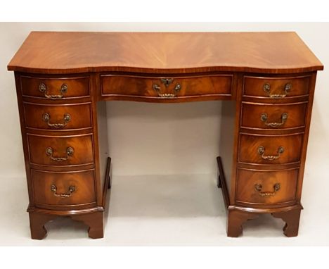 DESK, Georgian design mahogany serpentine fronted with an arrangement of nine drawers on bracket supports, 115cm W x 75cm H x