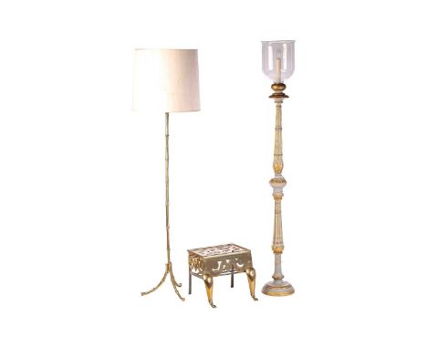 A "Hollywood Regency" gilt brass faux bamboo standard lamp, with an outswept tripod base, 167 cm overall height inclusive of 