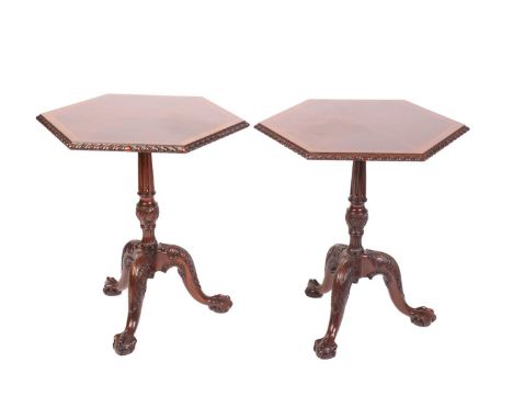 A pair of George III style carved mahogany hexagonal pillar tables, 20th century, with crossbanded and segmented top with hea