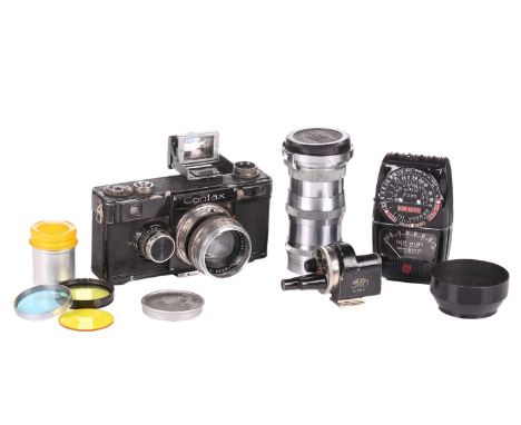 A Zeiss Ikon Contax 35mm rangefinder camera, contained in a vintage leather case, with assorted accessories.