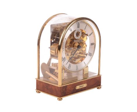 A Kieninger 8-day contemporary mantel clock, with brass arched and glazed case, with skeletal dial centre and secondary dial 