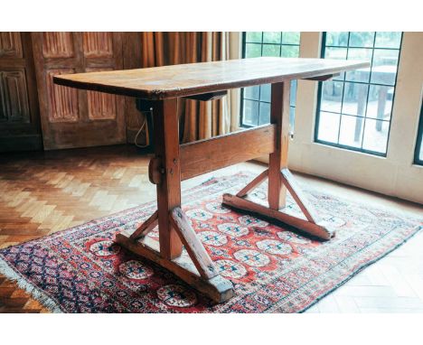 A 19th century stripped pine Gothic trestle type side table, with simple planked top and pegged architectural base, 75 cm hig