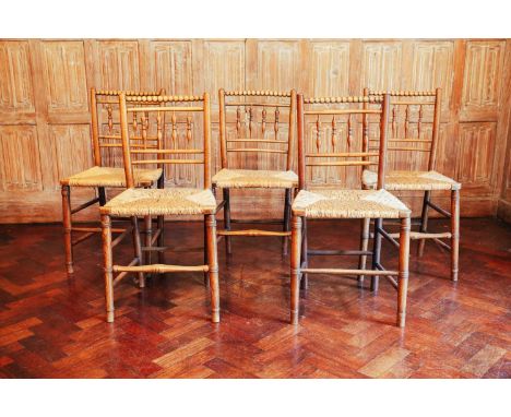 A matched set of five Victorian ash and rush-seated chairs, the bobbin-turned top rails over spindle-turned backs and ring-tu