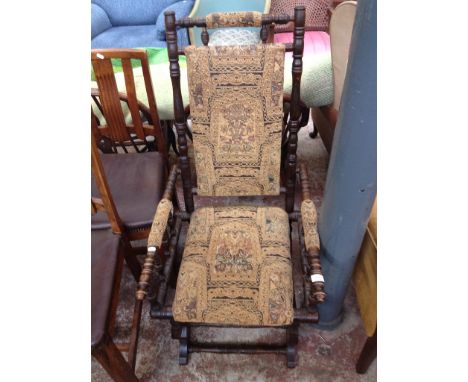 AN AMERICAN STYLE ROCKER WITH TAPESTRY STYLE UPHOLSTERY W54CM H105CM D70CM