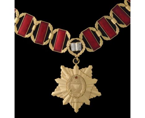 *North Korea, Doctor’s Medal, in gilt metal, width 57mm, with ten link collar in gilt and red enamel, with central link compr