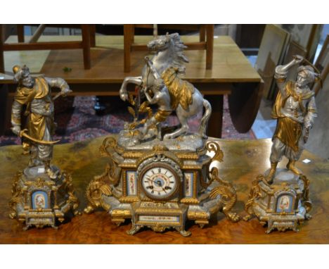 A Victorian painted spelter clock garniture de cheminee with porcelain dial and inset porcelain panels
