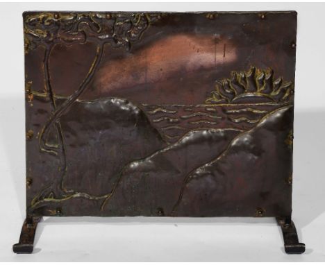 An Arts & Crafts copper fire screen showing a sun setting over the ocean, on shaped feet, 48cm high, 55cm wide