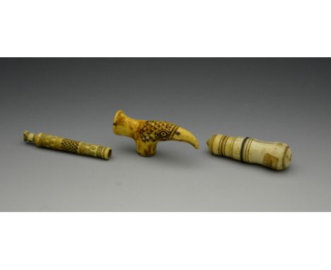 A European carved ivory needlecase , a bone stick handle in the form of an eagle's head and one other carved bodkin case (3)