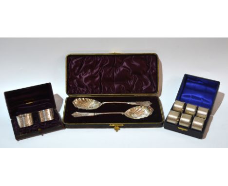 A pair of silver plated spoons of stylised form and original presentation box, together with a cased set of six silver plated