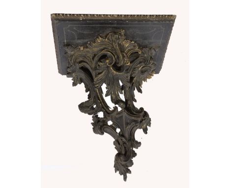 A 19th Century carved painted and giltwood wall bracket  of asymmetric Rococo form, 37cm across 