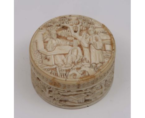 A Canton ivory carved circular patch box the cover having scholars under a pine tree, 4.25cm diameter, circa 1900