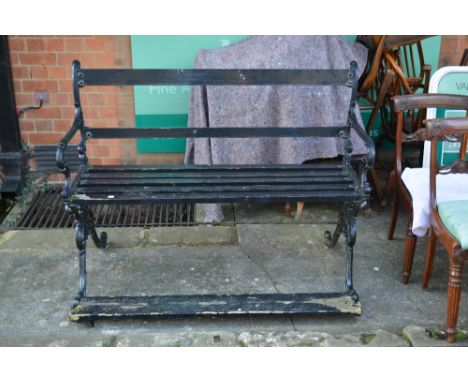 A Victorian black painted cast iron garden bench