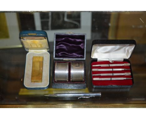 A silver propelling pencil with engine turned decoration, together with a gold plated cigarette lighter by Ronson, two cased 