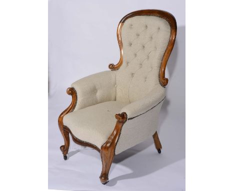 A Victorian mahogany framed armchair with button upholstery