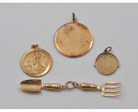 Miniature 9ct gold trowel and a matching fork, 9ct St Christopher and two other fobs.