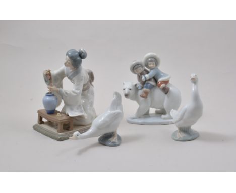 Lladro figure of Geisha tending a flower, 21cm, a Lladro group with two Inuit children on a Polar Bear, two Nao models of gee