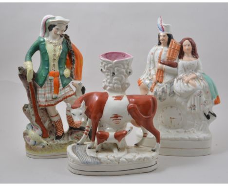 Staffordshire flat back clock group, created with a Scotch couple, 26cm, another Staffordshire figure of a Scotsman and three