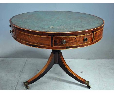 A Regency rosewood and inlaid Library Drum Table of circular form, the top inset with green and gilt tooled leather above fou