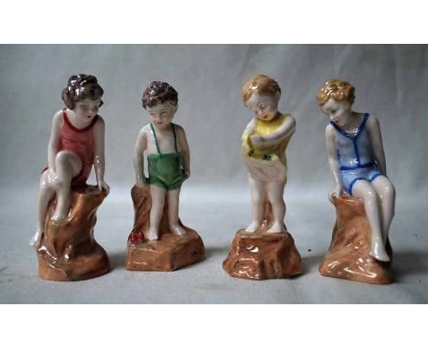 Four rare Royal Doulton Figures of Children, in prototype colourways, two girls in bathing costume sitting on a rock, girl in