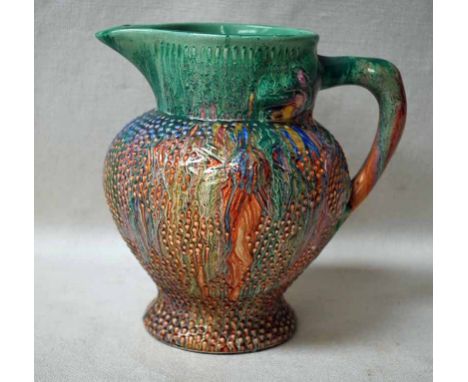 A Clarice Cliff Delicia Jug, dribble glazed in multicolours on beaded texture body, printed mark to underside, 18.5cm high 