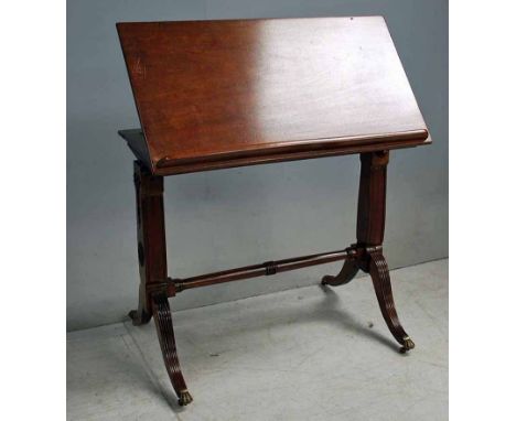 A Regency mahogany Reading Table with hinged rectangular top and adjustable strut support, removable from cheval style base w