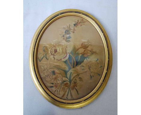 A late 18th century Silk Embroidered oval Panel depicting a still life of Flowers on gold ground, inscribed verso Worked by M