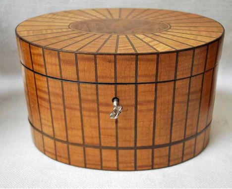 A Georgian style satinwood and line inlaid Tea Caddy, oval form with walnut inlaid hinged lid opening to reveal inner cover a