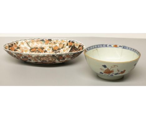 C20th Japanese Imari wave edged oval dish, W35cm (A/F), and a C19th Imari circular bowl decorated with flower and fence patte