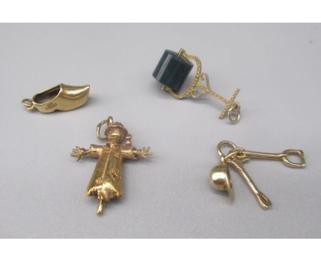 Three 9ct yellow gold charms, including a scarecrow, a clog, helmet and tool, all stamped 375, gross 7.4g and a yellow metal 