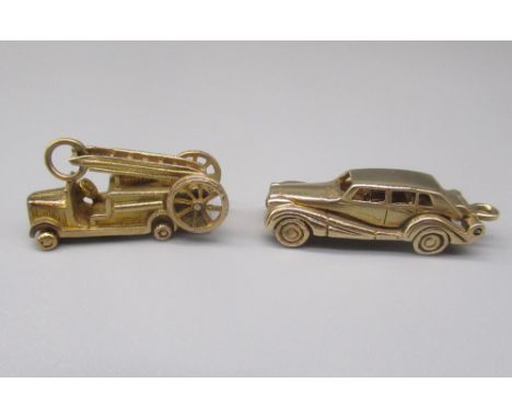 Two 9ct yellow gold charms including a fire engine and a saloon car opening to reveal interior, both stamped 375, 11.7g 