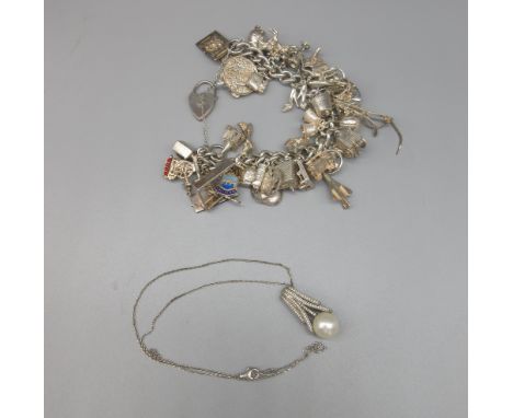 Hallmarked Sterling silver charm bracelet with a quantity of silver and white metal charms, 137.3g, and a silver pendant neck