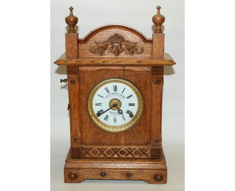 Fattorini &amp; Sons early C20th oak cased patent automatic alarm clock with signed enamel dial and registered patent number 