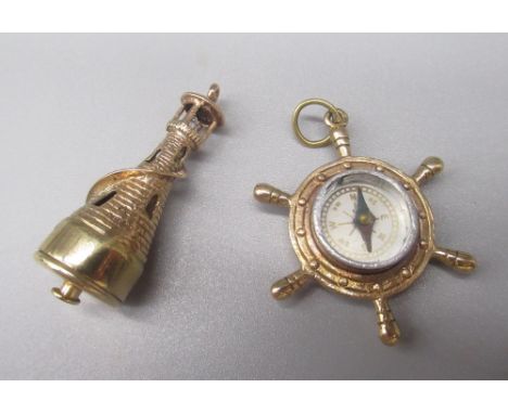 Two 9ct yellow gold charms including a lighthouse and a ships wheel compass, both stamped 375, 13.5g 