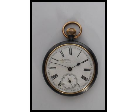 A early 20th century white metal open face pocket watch, having white enamel face with roman numerals on the chapter ring, se