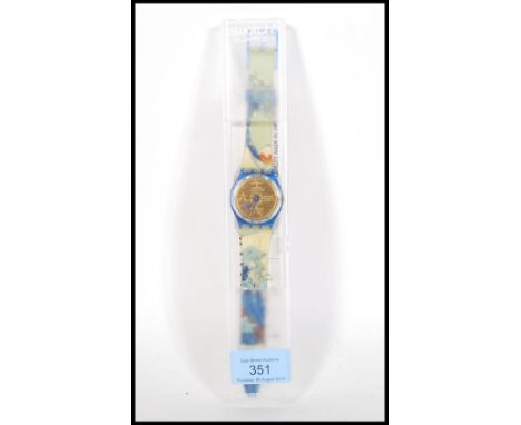 A collectors wrist watch by Swatch quartz water resistant having gilt face with Chinese character marks on a plastic strap de