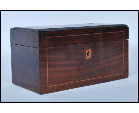 A 19th Century French walnut inlaid tea caddy of rectangular form having a birdseye maple veneered interior with two lidded c