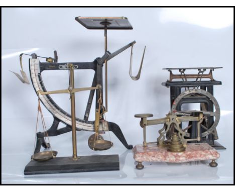 A collection of four sets of scales dating from the 19th Century to include a set of VictorianPostage scales with weights set