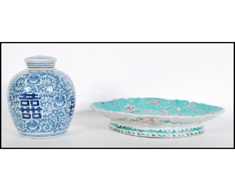 A late 19th Century Chinese dish / tazza having scalloped edge with turquoise ground and enamel floral detailing raised on sc