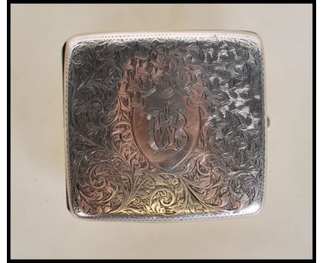 A silver hallmarked cigarette case&nbsp;of shaped bowed rectangular form having engraved foliate design to front and verso, w
