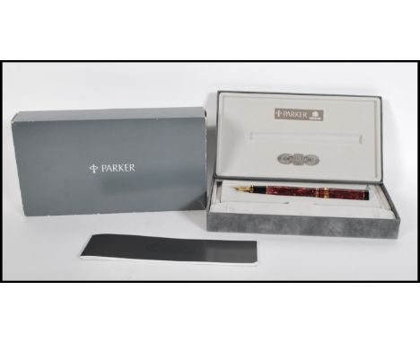 A boxed Parker, Duofold Centennial, maroon marbled fountain pen, the cap with gilt arrow clip and double cap band, the medium
