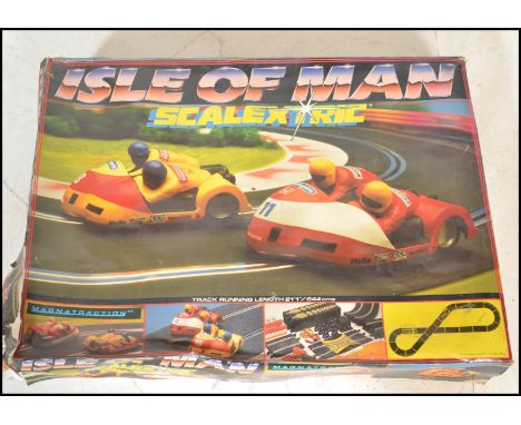 A vintage Scalextric slot car racing set ' Isle Of Man '. Including both bikes and track. Within the original box. Used condi
