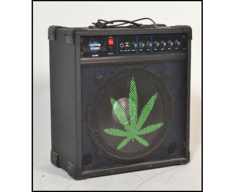 A Custom Sound guitar amplifier model no. CS100B in black, with a leaf painted to the front.&nbsp;