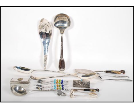 A collection of 20th Century kitchenalia to include a stamped 800 silver ladle with floral garland decoration, a Lebanese cak