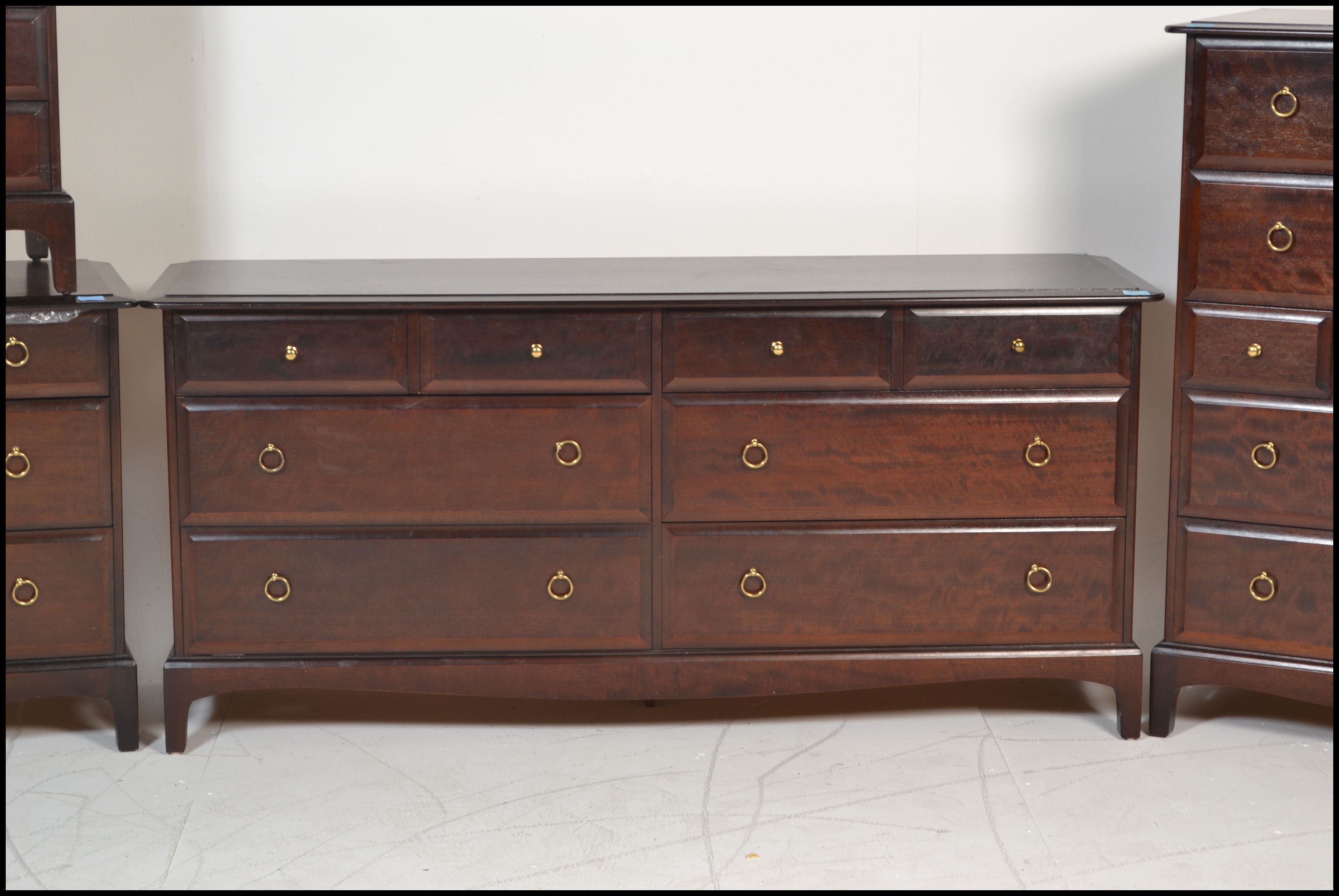 A Stag mahogany ' minstrel ' pattern bedroom suite comprising a large double chest of drawers, a