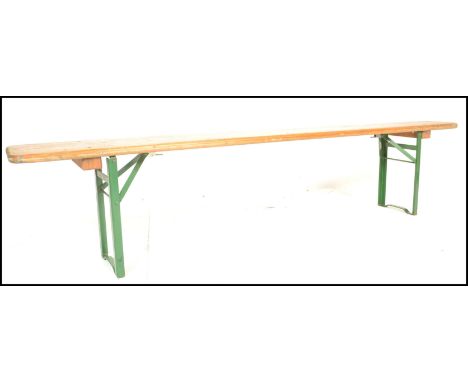 A mid 20th Century Industrial factory work bench. Of panelled wood with folding metal legs being stamped to the underside, be