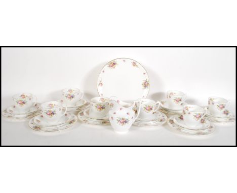 A early 20th Century Edwardian Royal Doulton tea service having floral sprays on white ground with gilt rims. The tea set con