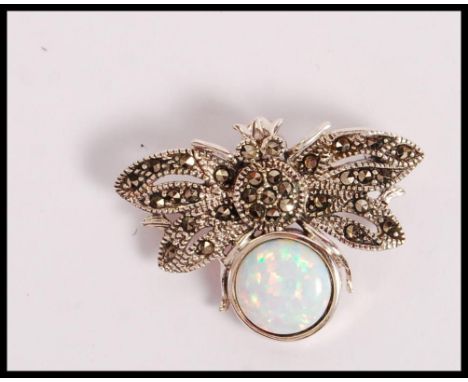 A stamped 925 silver bug brooch being set with a round opal panel and marcasites. Weight 6.2g. Measures 3.2cm.&nbsp;